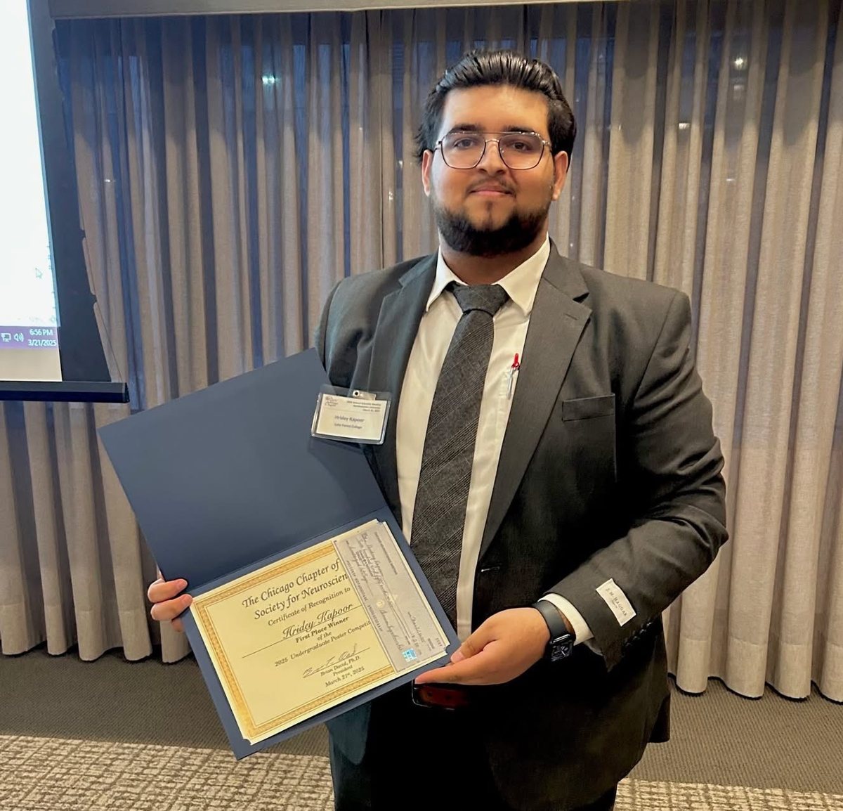 Hridey Kapoor holding the 1st-place certificate from the Chicago Society for Neuroscience, 2025